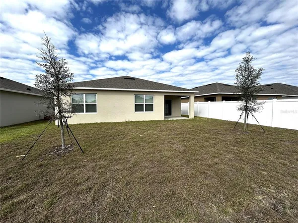 a house with trees in the background