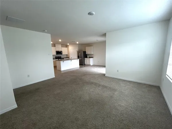 a view of a livingroom with a kitchen