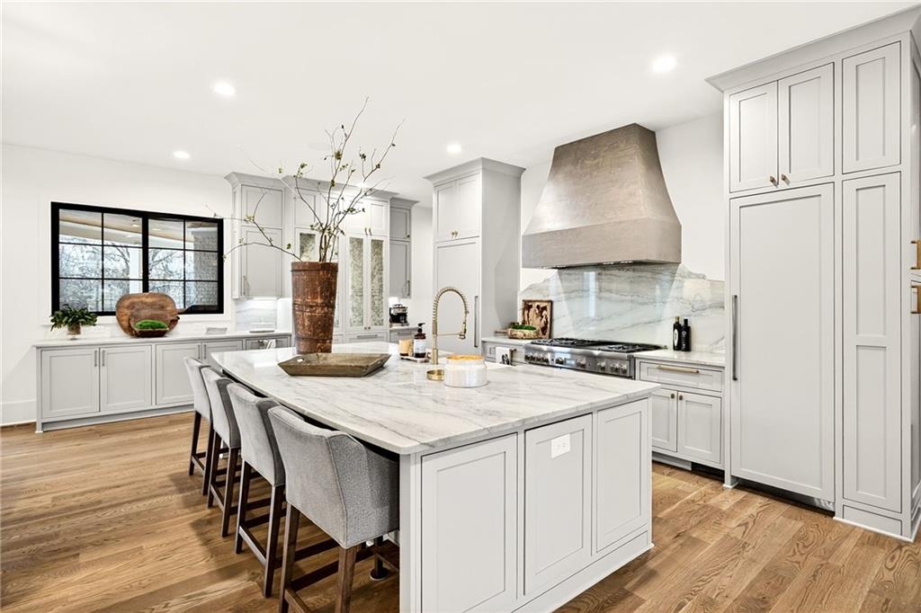 150 Fortress Way Jefferson, GA 30549 - Photo 12 of 83 a kitchen with a stove a sink a dining table and chairs