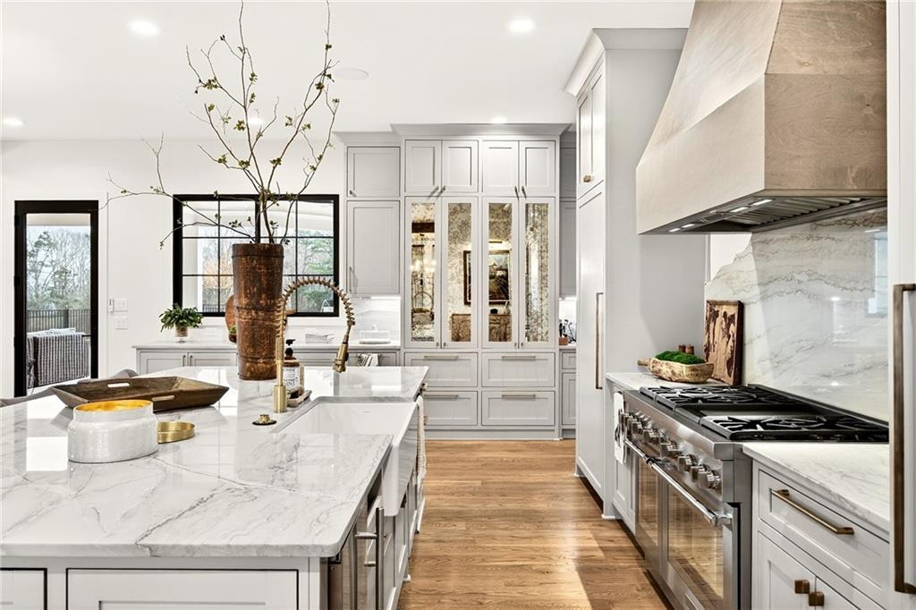 150 Fortress Way Jefferson, GA 30549 - Photo 15 of 83 a kitchen with stainless steel appliances kitchen island granite countertop a stove and a white cabinets