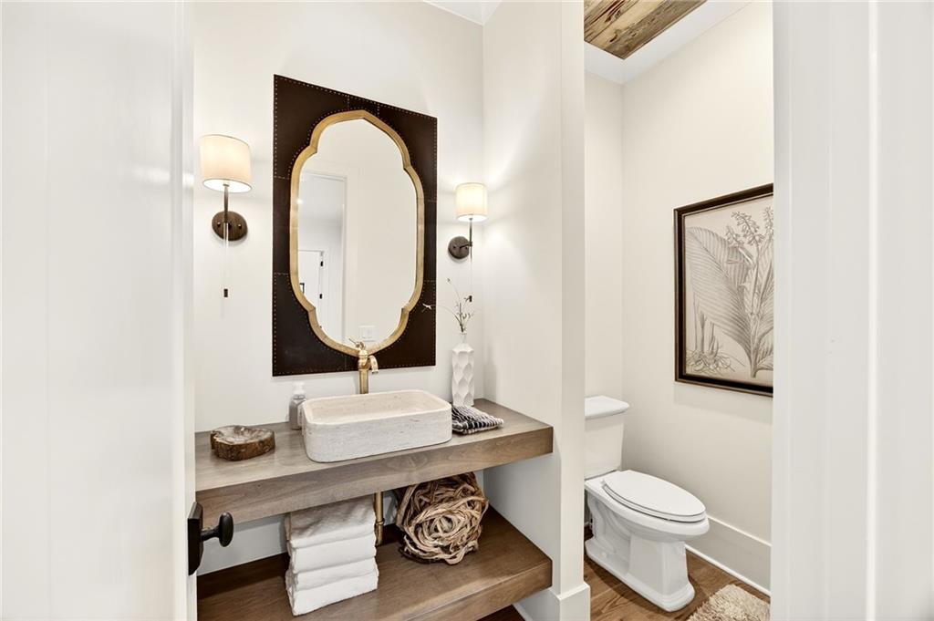 150 Fortress Way Jefferson, GA 30549 - Photo 18 of 83 a bathroom with a toilet a sink and a mirror