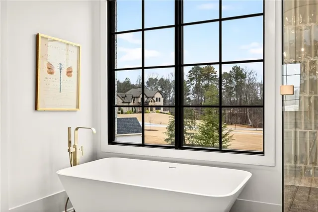 a kitchen with granite countertop a stove a sink dishwasher a dining table and chairs with wooden floor