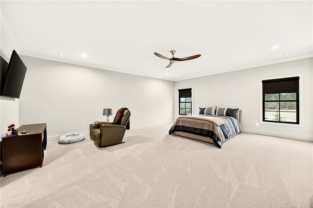 150 Fortress Way Jefferson, GA 30549 - Photo 29 of 83 a bedroom with a bed and a flat screen tv