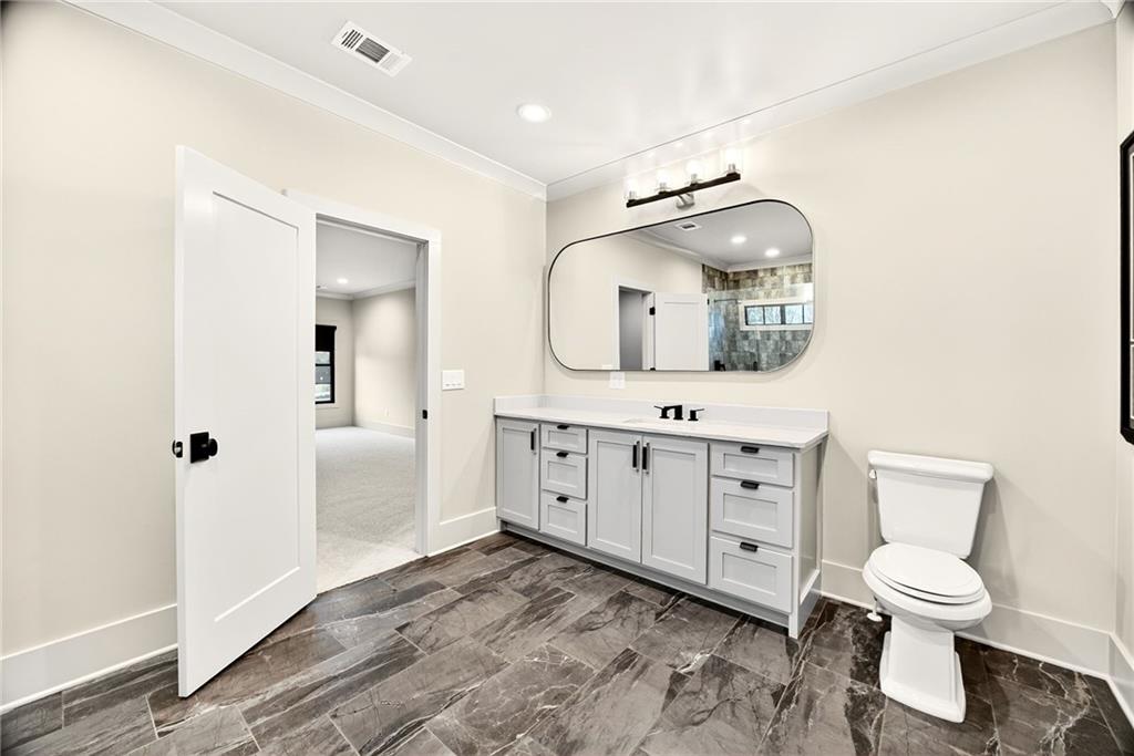 150 Fortress Way Jefferson, GA 30549 - Photo 30 of 83 a spacious bathroom with a toilet sink and mirror