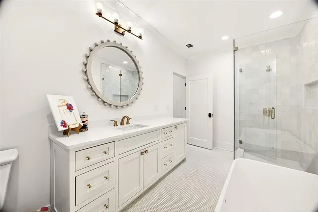 a bathroom with a toilet a sink a mirror and a shower