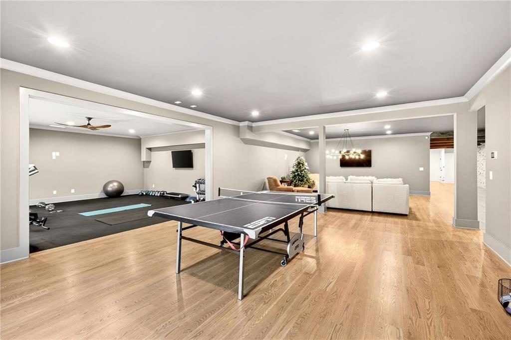 150 Fortress Way Jefferson, GA 30549 - Photo 48 of 83 a living room with furniture a flat screen tv and a wooden floor