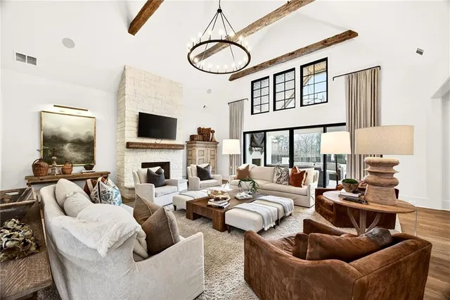 a kitchen with a stove a sink a dining table and chairs