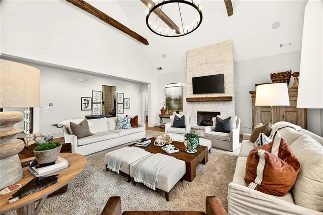 a living room with furniture a fireplace and a flat screen tv