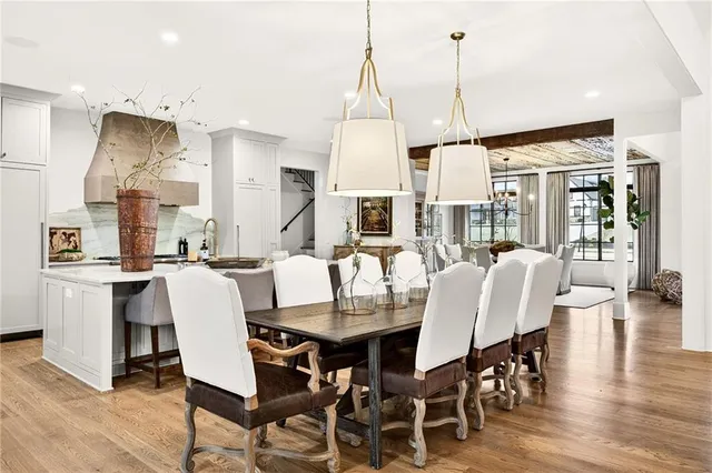 a kitchen with stainless steel appliances kitchen island granite countertop a stove and a white cabinets
