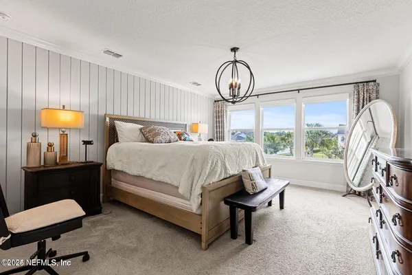 a bed room with a bed and a chandelier