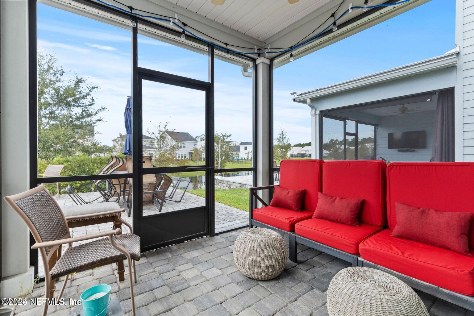 35 Clifton Bay Loop St. Johns, FL 32259 - Photo 21 of 24 a living room with furniture and a floor to ceiling window