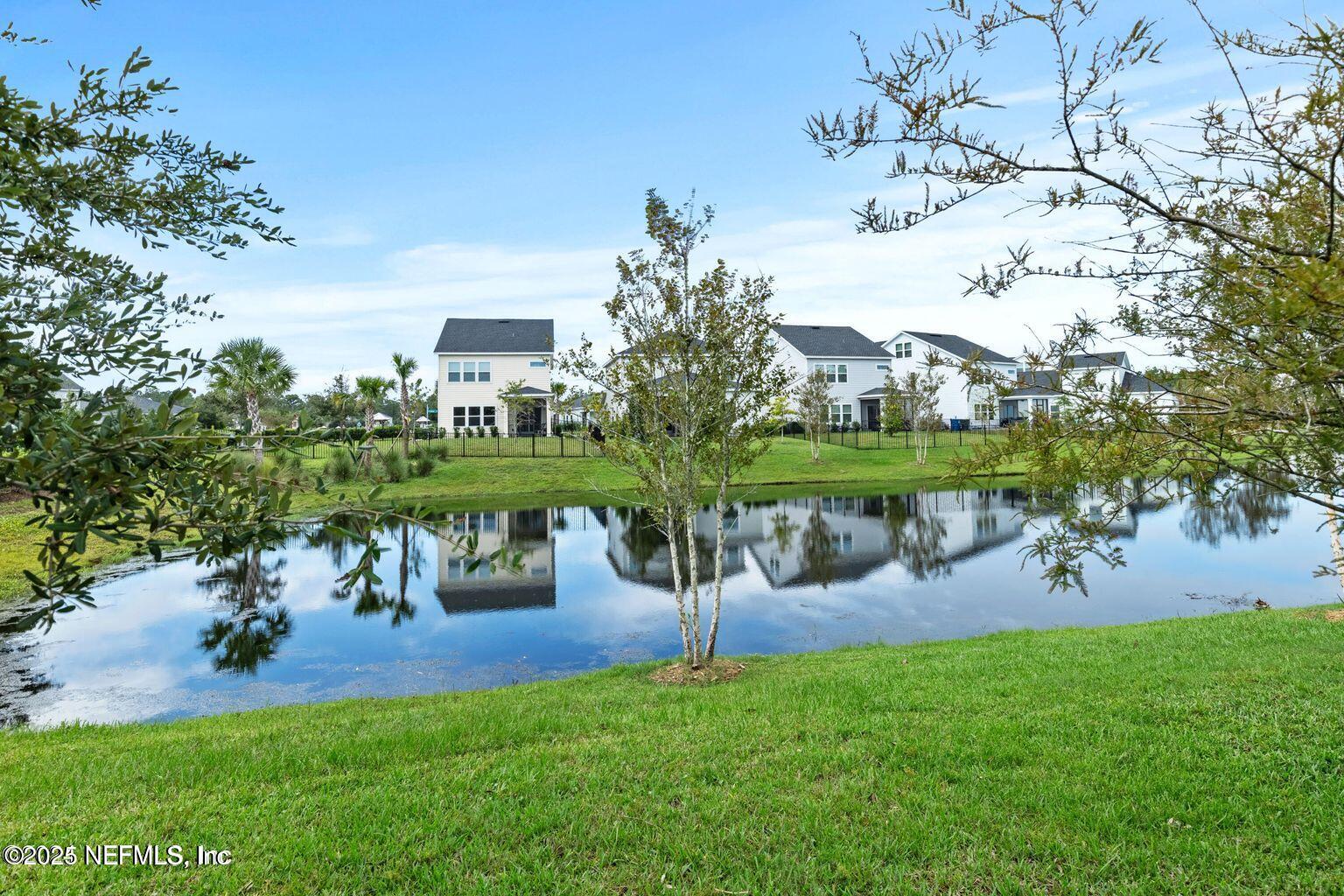35 Clifton Bay Loop St. Johns, FL 32259 - Photo 23 of 24 a view of a lake with a yard and a fountain