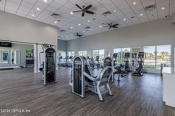 a view of a livingroom with furniture and a gym