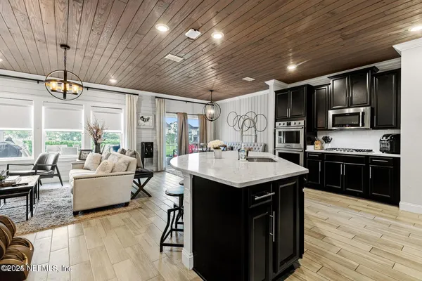 a kitchen with a sink stainless steel appliances and furniture