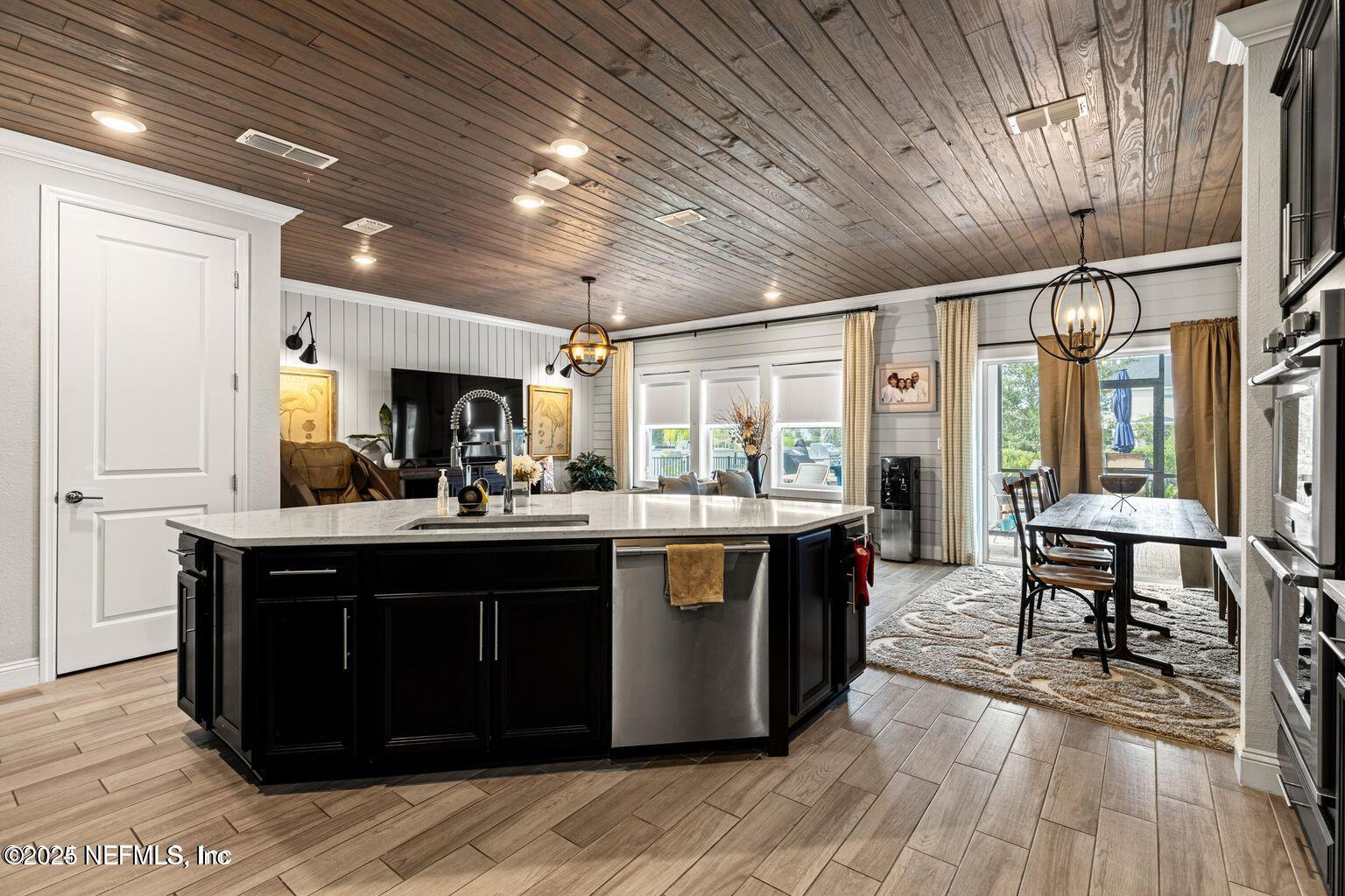 35 Clifton Bay Loop St. Johns, FL 32259 - Photo 10 of 24 a kitchen with stainless steel appliances granite countertop a sink a counter space and wooden floors