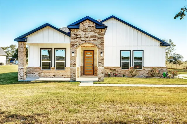 a view of a house with a swimming pool and a yard