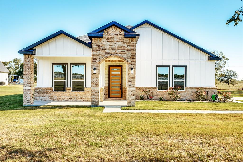 a view of a house with a swimming pool and a yard