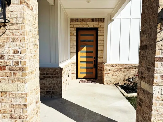 a view of a bedroom with wooden floor