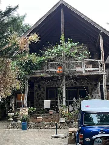 a front view of house with car parked