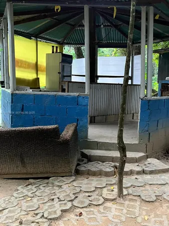 a view of a porch with furniture and a yard