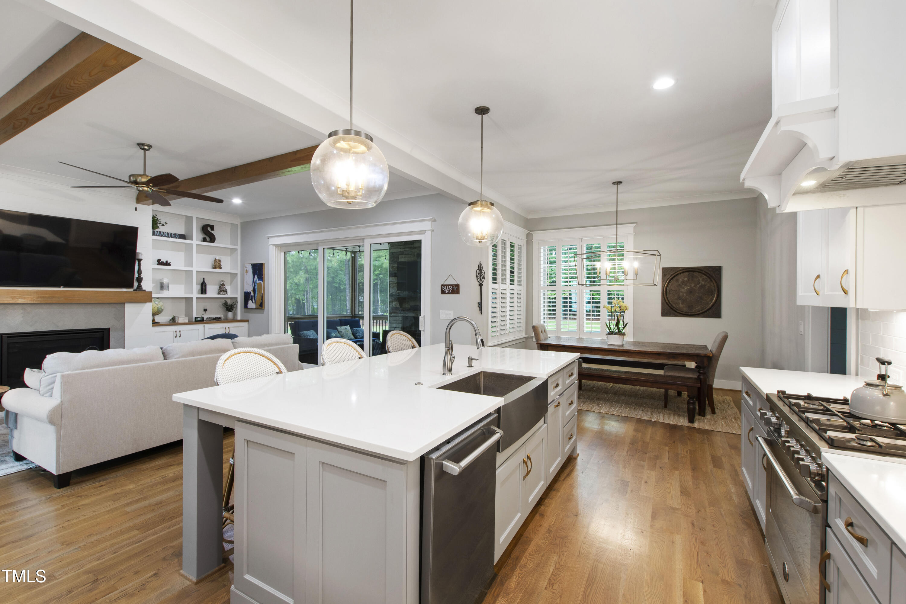 713 Brownwich Street Wake Forest, NC 27587 - Photo 16 of 78 a large kitchen with kitchen island a stove a sink a dining table and chairs with wooden floor