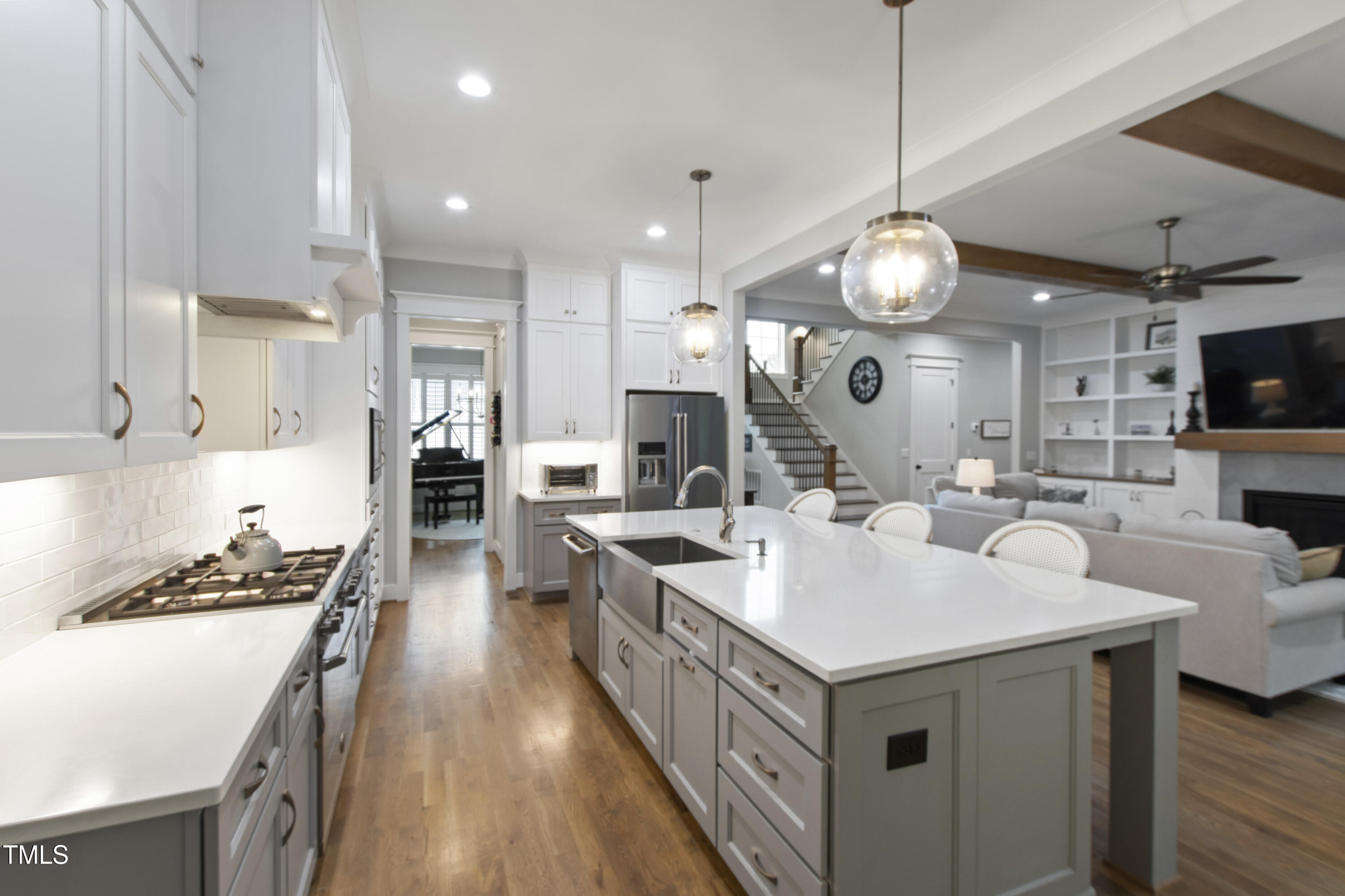 713 Brownwich Street Wake Forest, NC 27587 - Photo 18 of 78 a large kitchen with stainless steel appliances a stove a sink dishwasher and a dining table with wooden floor
