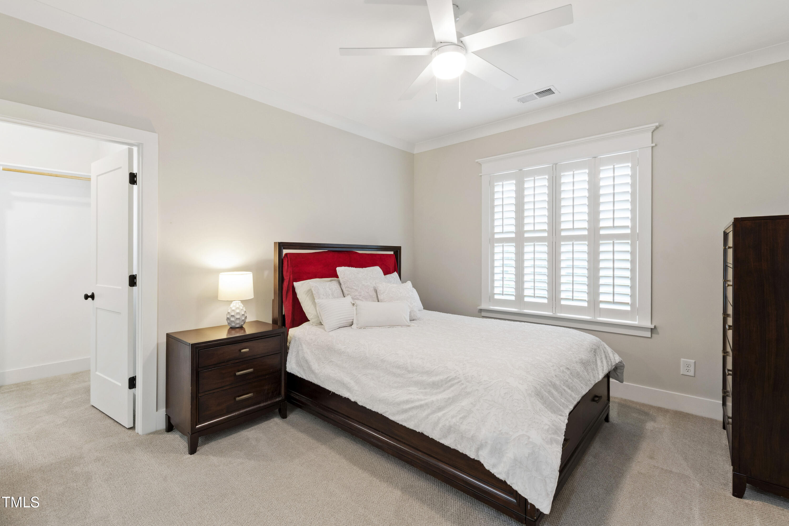 713 Brownwich Street Wake Forest, NC 27587 - Photo 48 of 78 a bedroom with a bed and a chandelier