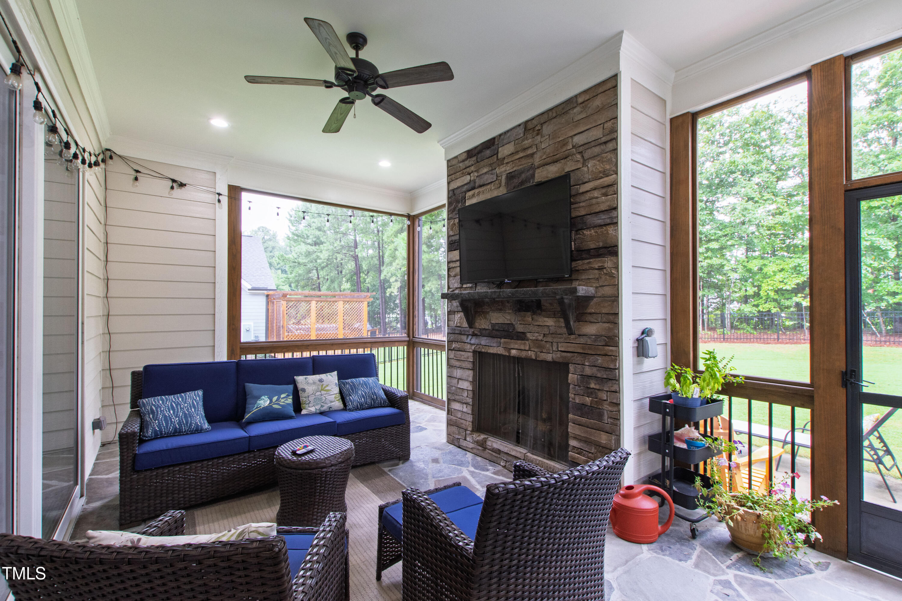 713 Brownwich Street Wake Forest, NC 27587 - Photo 60 of 78 a living room with furniture a flat screen tv and a fireplace