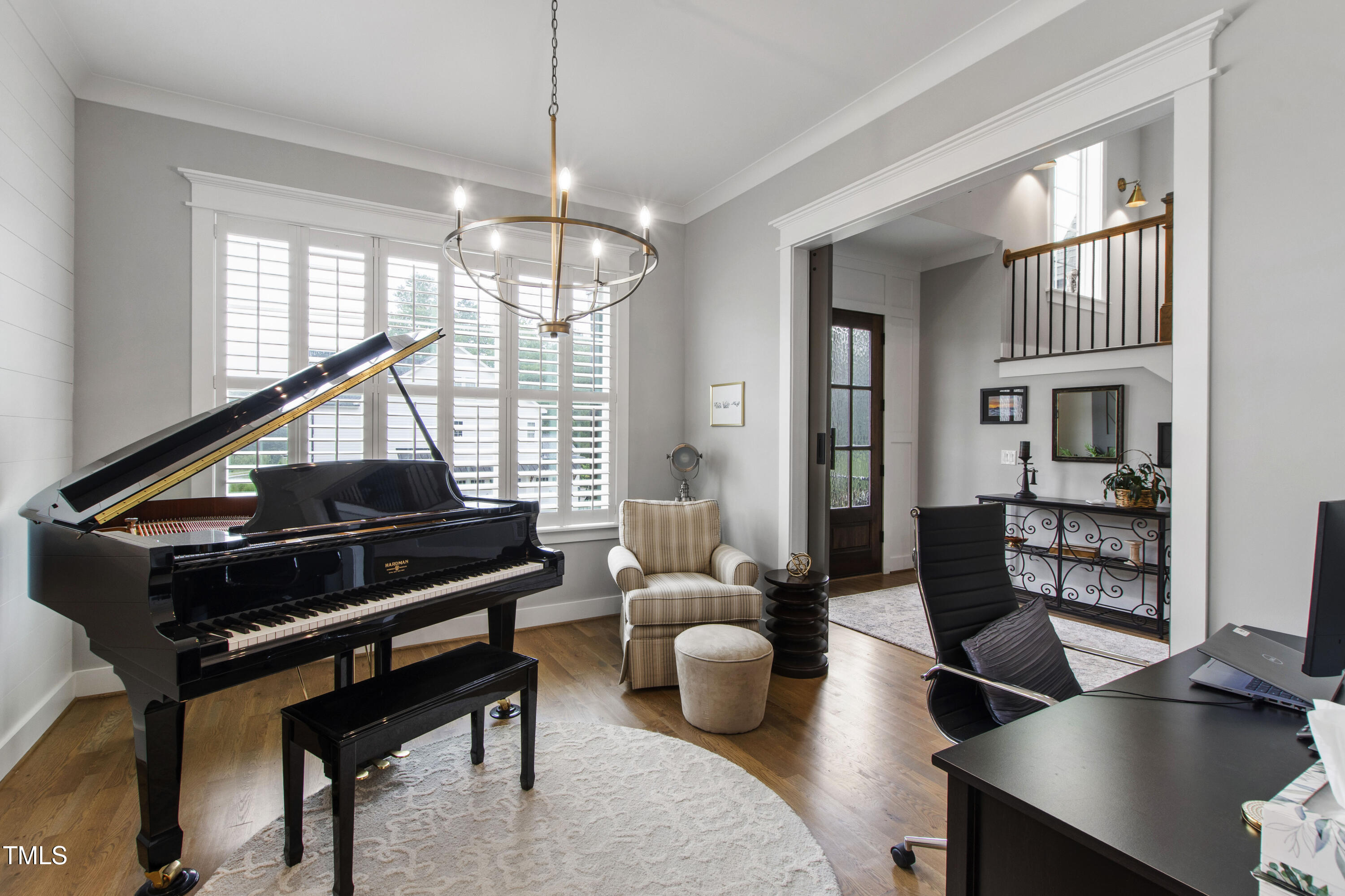 713 Brownwich Street Wake Forest, NC 27587 - Photo 8 of 78 a living room with furniture a rug and a chandelier