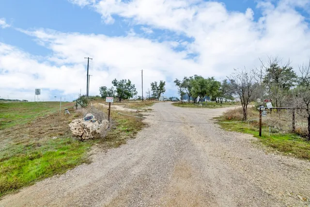 a view of a yard with wooden fence