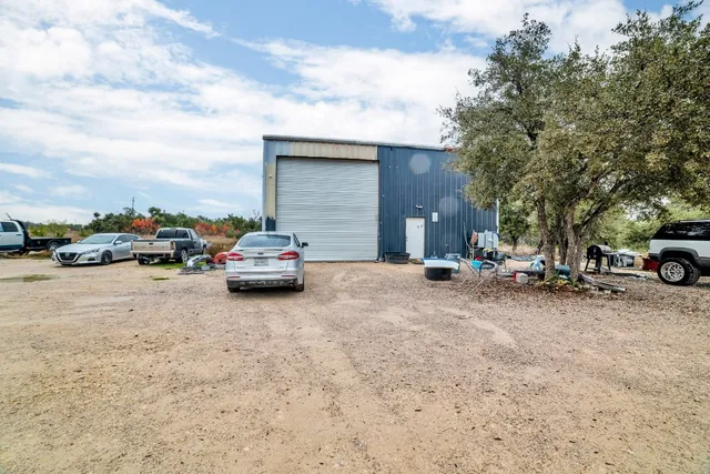 a view of car parked on road with house