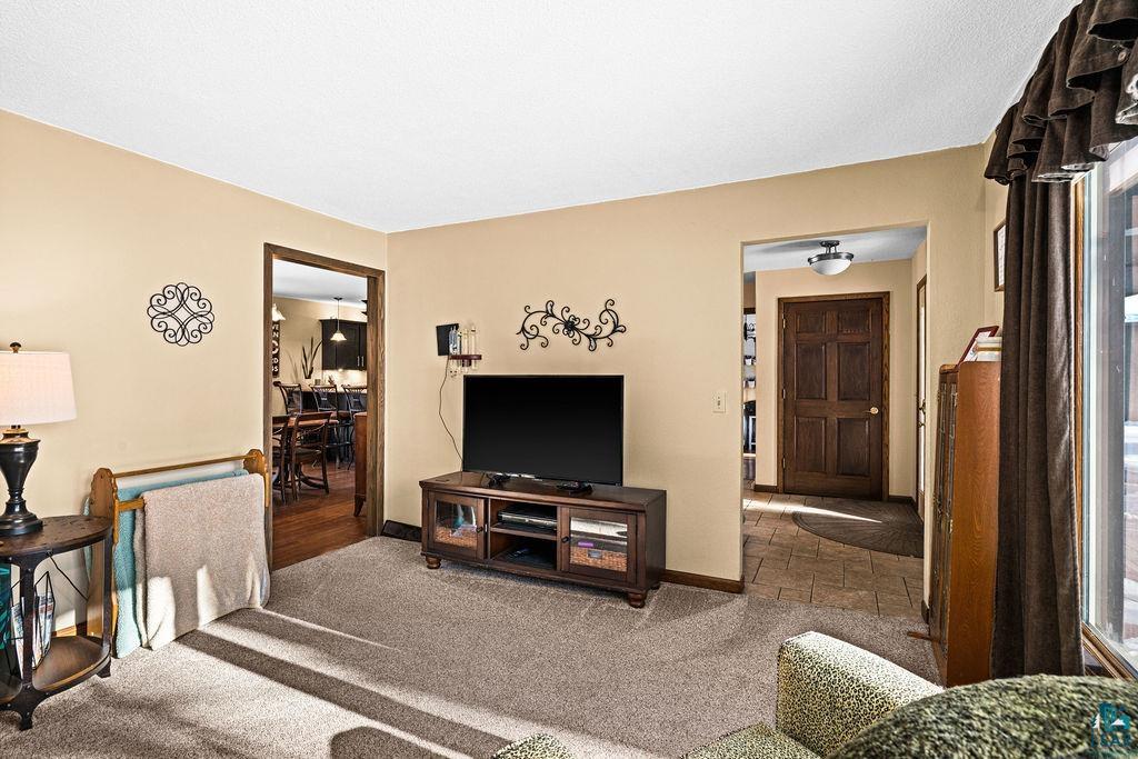 421 St Louis River Road Proctor, MN 55810 - Photo 11 of 57 Living area featuring carpet floors and baseboards