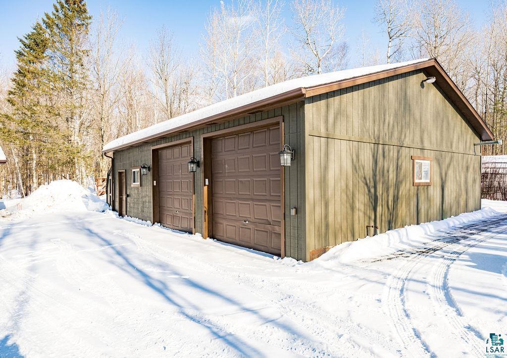 421 St Louis River Road Proctor, MN 55810 - Photo 15 of 57 Snow covered garage featuring a garage