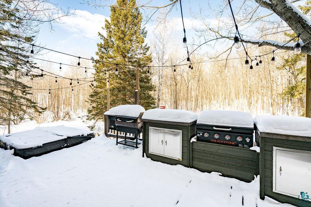 421 St Louis River Road Proctor, MN 55810 - Photo 23 of 57 Yard layered in snow with a deck