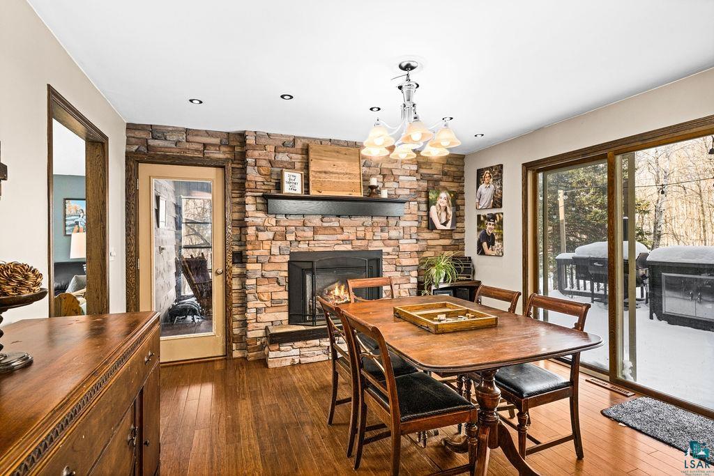 421 St Louis River Road Proctor, MN 55810 - Photo 3 of 57 Dining room with dark wood-type flooring, a chandelier, and a fireplace