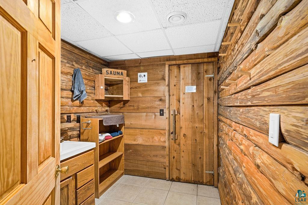 421 St Louis River Road Proctor, MN 55810 - Photo 46 of 57 Mudroom with a paneled ceiling, wooden walls, and light tile patterned floors