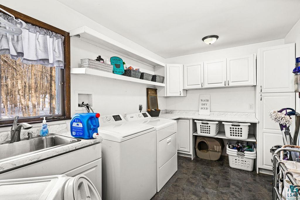 421 St Louis River Road Proctor, MN 55810 - Photo 7 of 57 Laundry area featuring washing machine and clothes dryer and cabinet space