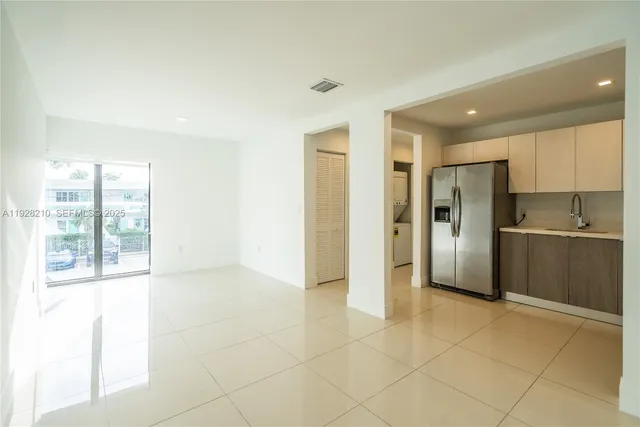 a view of a kitchen with a sink and a refrigerator