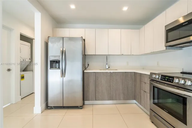a kitchen with stainless steel appliances granite countertop a refrigerator and a stove top oven