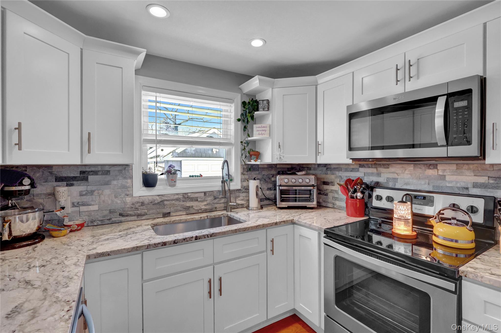 522 Browns Road Nesconset, NY 11767 - Photo 11 of 29 a kitchen with cabinets stainless steel appliances a sink and a window