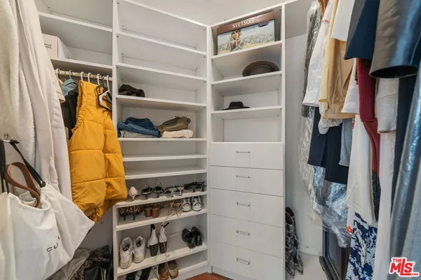 a spacious bathroom with a granite countertop sink mirror vanity and toilet