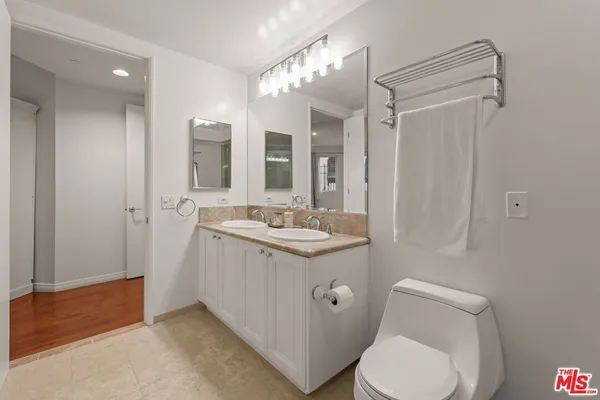 a bedroom with a bed and a lamp