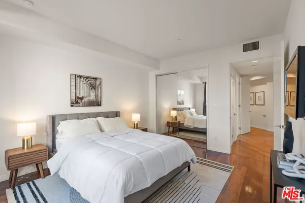 a bedroom with a bed and a flat screen tv