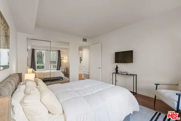 a spacious bathroom with a toilet a sink and a mirror