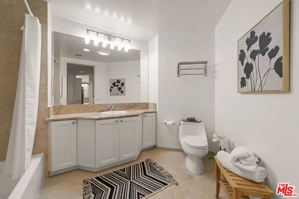 a view of a balcony with two chairs and a potted plant
