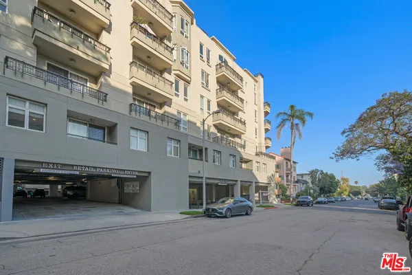 a balcony with wooden floor and bench