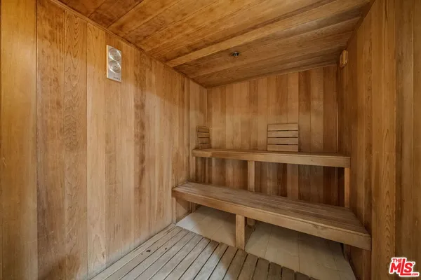 a room with furniture pool table and a wooden floor