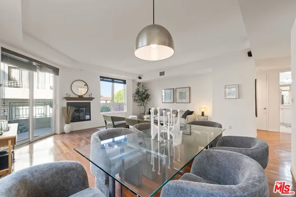 a living room with fireplace furniture and a wooden floor