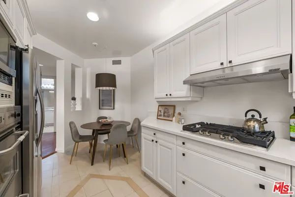 a kitchen with stainless steel appliances a stove microwave and cabinets