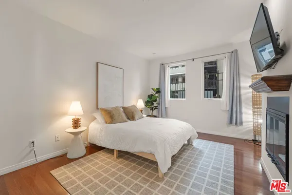 a bedroom with a bed and a flat screen tv